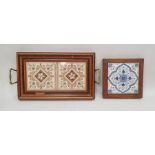 Wooden two-handled tray inset two old printed ceramic tiles and with embossed brass handles, 43cm