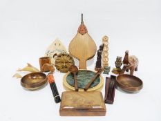 Carved wooden model of an elephant, various turned wooden bowls, pair of bellows, a large wicker