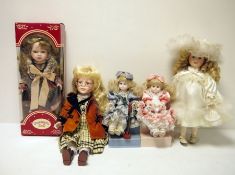 Two boxes of modern porcelain collector's dolls  and The Discovery Store GP Race Rider Bike,