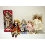 Two boxes of modern porcelain collector's dolls  and The Discovery Store GP Race Rider Bike,