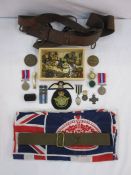 Collection of British military buttons, badges and WWI I medals and a WWI officers leather Sam Brown
