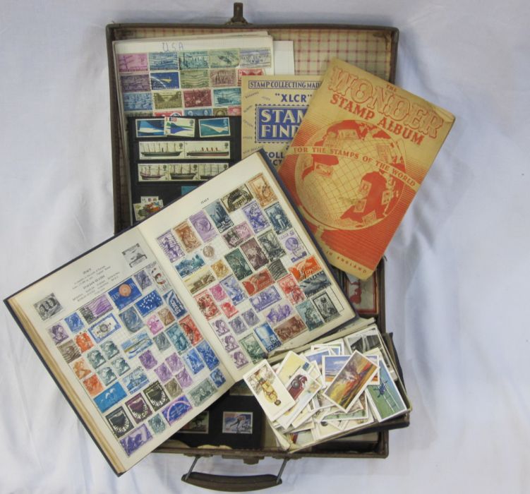 Suitcase with three albums and various loose stamps. First day covers and few on leaves. Mostly