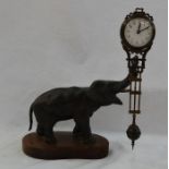 Spelter Elephant pendulum clock. Pendulum with enamel dial, floral and scroll decoration, all on