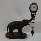 Spelter Elephant pendulum clock. Pendulum with enamel dial, floral and scroll decoration, all on