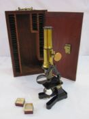 Mahogany cased microscope with various glass slides (mostly empty) and set of boxed glass circles