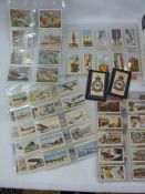 3 Wills cigarette cards album of British Empire overseas, Trains and bicycles, household hits.