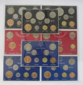 Coin sets made up of all circulated coins of the period, housed in plastic sheets, most coins in EF