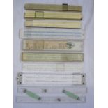 Collection of 9 vintage slide rulers in contemporary cases