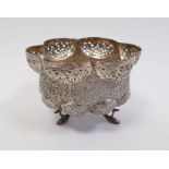 Indian/Burmese white metal lobed bowl with pierced and engraved decoration, raised on three fish-