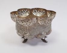 Indian/Burmese white metal lobed bowl with pierced and engraved decoration, raised on three fish-