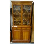 20th century yew bookcase cabinet, the moulded cornice above two astragal-glazed doors enclosing