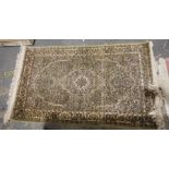 Silk eastern style rug, green ground foliate field with brown ground central medallion and