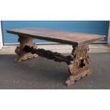 17th/18th century Italian walnut trestle table, the rectangular top on carved and shaped end