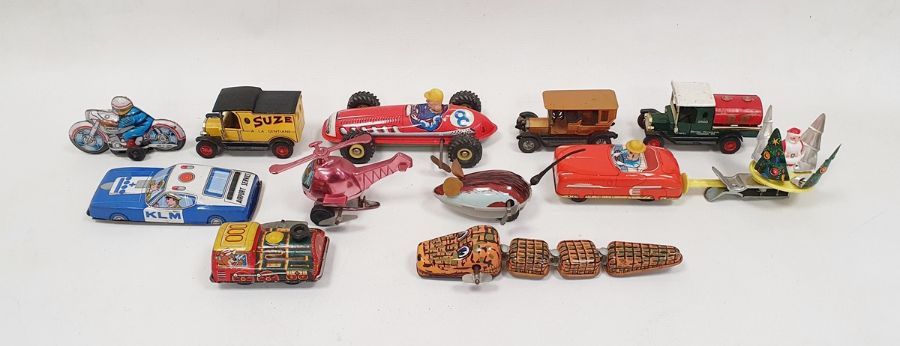 Assorted clockwork toys to include mouse, police car, racecar, Santa toy, crocodile and motorbike