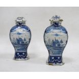 Pair of Dutch Delft baluster vases and fixed covers, 18th/19th century, blue 108 over star mark,