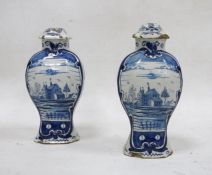 Pair of Dutch Delft baluster vases and fixed covers, 18th/19th century, blue 108 over star mark,