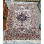 Modern Persian-style rug, cream ground foliate decorated field with a blue ground central medallion,