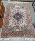 Modern Persian-style rug, cream ground foliate decorated field with a blue ground central medallion,