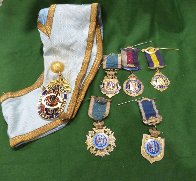 11 silver-gilt  and enamel masonic medals, a large gilt metal and enamel masonic medal attached to