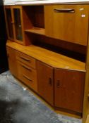 Mid-century modern G-Plan teak lounge unit, the top with glazed cupboard doors, assorted shelves and