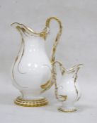 Pair of English porcelain white and gilt Rockingham style jugs in sizes, mid 19th century each