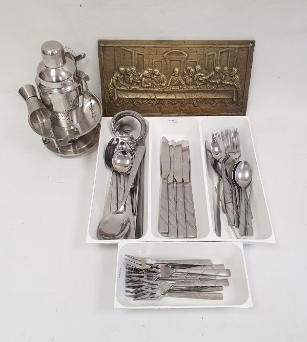 Stainless steel flatware by Royalty Line, a cocktail shaker and a brass plaque featuring The Last