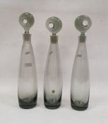 Three Holmegaard smokey glass decantersCondition Report Some wear to stoppers and bases.