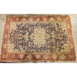 Persian rug with cream ground foliate pattern central medallion on a blue ground foliate decorated