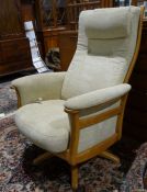 Modern Ercol reclining easy chair in beige upholstery
