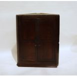 Georgian oak wall-hanging corner cupboard, the two panelled doors enclosing shelves and four short