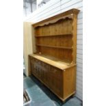 20th century pine dresser, the moulded cornice above open shelves, four drawers, four cupboard