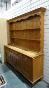 20th century pine dresser, the moulded cornice above open shelves, four drawers, four cupboard