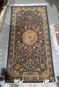 Modern Persian-style rug with central gold ground medallion on black ground foliate decorated