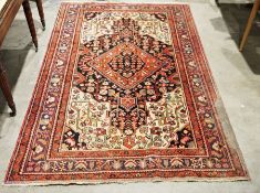 Persian rug with diamond-shaped central medallion on a black ground foliate field, cream ground