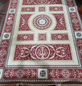 Modern carpet, cream ground with red ground panels and stepped border, 337cm x 245cm