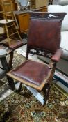 Folding chair with red leather upholstered back, seat and arms