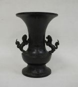 Japanese bronze flared baluster vase, Meiji, applied with two lion dog handles, the body decorated