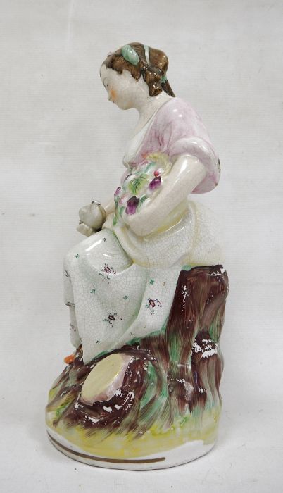 Staffordshire pottery figure of a lady vintner, late 19th century, she modelled seated holding a - Bild 2 aus 5