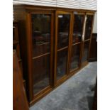 20th century mahogany bookcase with four large glazed doors enclosing adjustable shelves, raised