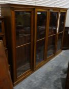 20th century mahogany bookcase with four large glazed doors enclosing adjustable shelves, raised