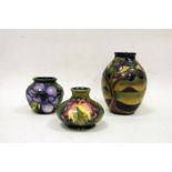 Three Moorcroft vases to include ovoid vase with tree in landscape design, squat baluster vase