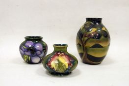 Three Moorcroft vases to include ovoid vase with tree in landscape design, squat baluster vase