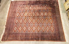 Modern Bokhara-type carpet with repeating cream ground motifs, stepped border, 234cm x 188cm