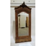 Continental walnut armoire with carved pediment, mirrored door, on bracket feet, 104cm x 240cm