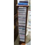 A quantity of Classical CDs to include Mozart, Grieg etc along with a Modern Wooden CD tower.