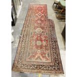 Persian runner with pink ground foliate field, stepped border, approx. 350cm x 105cm