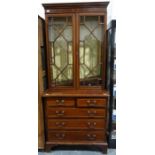 Edwardian mahogany and satinwood banded bookcase cabinet, the moulded cornice above two astragal-