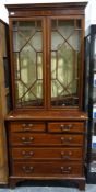 Edwardian mahogany and satinwood banded bookcase cabinet, the moulded cornice above two astragal-