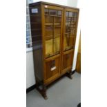 Early 20th century oak display cabinet with astragal-glazed door enclosing shelves, on turned and