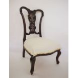 Low Victorian bedroom chair in Chippendale style, with carved back, on cabriole front legs